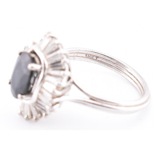 23A - An 18ct white gold sapphire and diamond ballerina cluster ring. The 18ct white gold ring set with a ... 