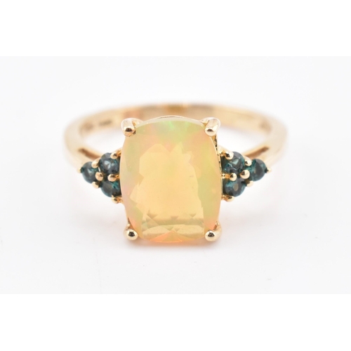 240 - A hallmarked 9ct gold Ethiopian opal and Arusha colour change garnet ring. The 9ct yellow gold ring ... 