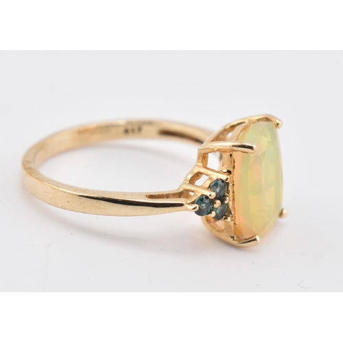 240 - A hallmarked 9ct gold Ethiopian opal and Arusha colour change garnet ring. The 9ct yellow gold ring ... 