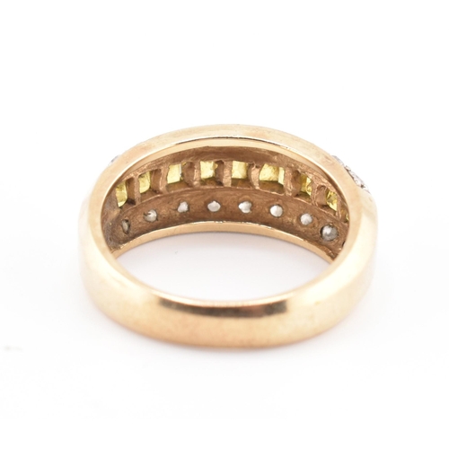 245 - A hallmarked 9ct gold, yellow sapphire and diamond ring. The 9ct yellow gold ring having a central r... 