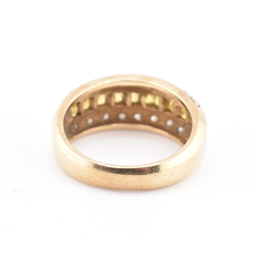 245 - A hallmarked 9ct gold, yellow sapphire and diamond ring. The 9ct yellow gold ring having a central r... 