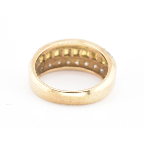 245 - A hallmarked 9ct gold, yellow sapphire and diamond ring. The 9ct yellow gold ring having a central r... 