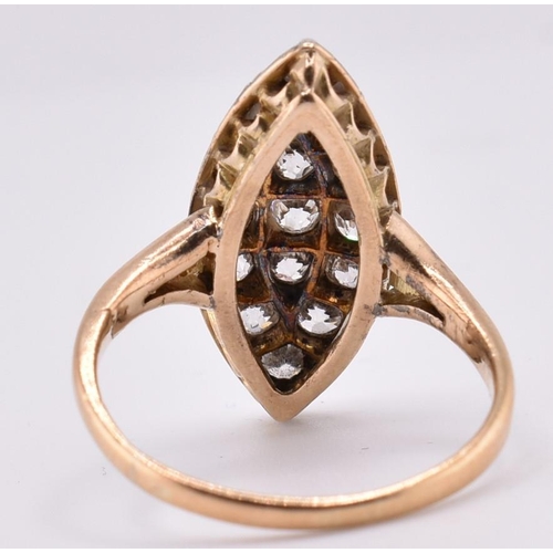 24A - A gold and diamond navette ring. The gold yellow gold navette ring set with fifteen old cut diamonds... 