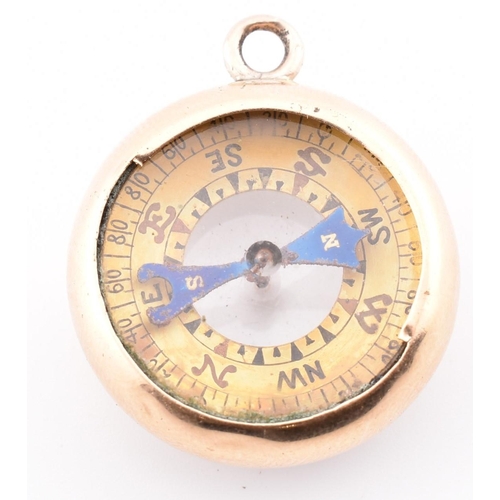 25 - A gold dual compass and barometer pendant. The gold pendant having a compass on one side with a baro... 