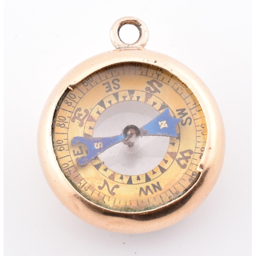 25 - A gold dual compass and barometer pendant. The gold pendant having a compass on one side with a baro... 