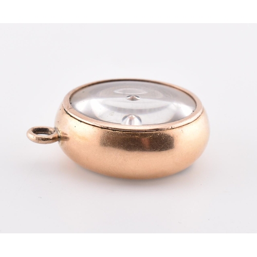 25 - A gold dual compass and barometer pendant. The gold pendant having a compass on one side with a baro... 