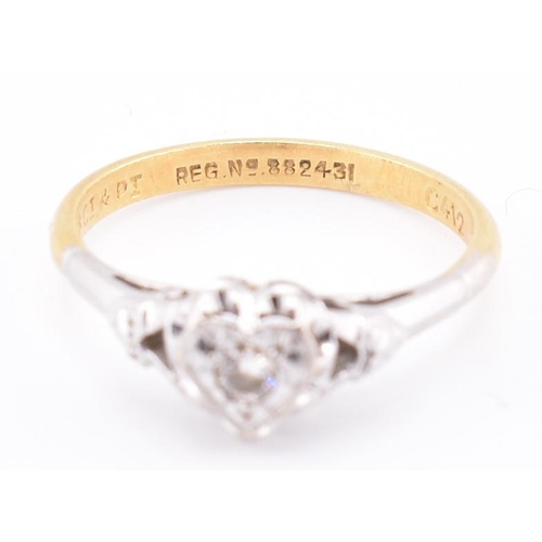 251 - A 1950s 18ct gold and platinum diamond solitaire heart ring. The 1950s 18ct yellow gold and platinum... 