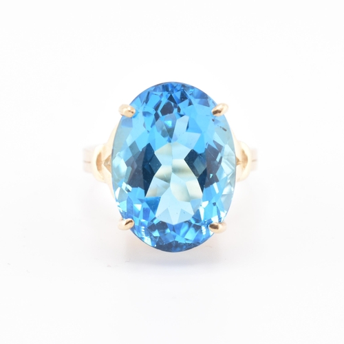 252 - A hallmarked 9ct gold and Swiss blue topaz ring. The 9ct yellow gold ring set with a single four cla... 