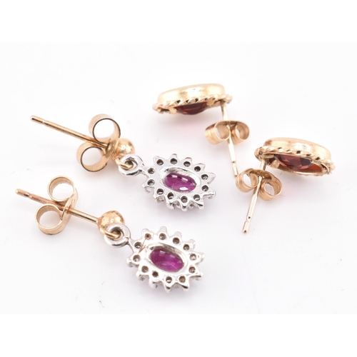 253 - Two pairs of gold and gem set earrings. The lot to include a pair of 9ct gold and red stone stud ear... 