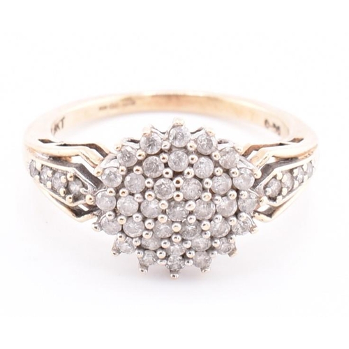 254 - A hallmarked 9ct gold and diamond cluster ring. The 9ct yellow gold ring set with a round cluster of... 