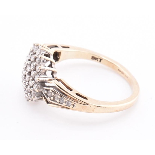 254 - A hallmarked 9ct gold and diamond cluster ring. The 9ct yellow gold ring set with a round cluster of... 