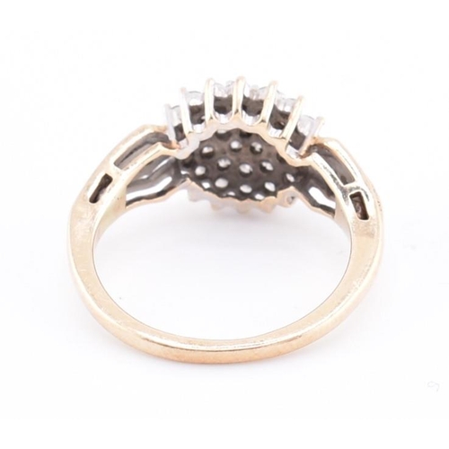 254 - A hallmarked 9ct gold and diamond cluster ring. The 9ct yellow gold ring set with a round cluster of... 