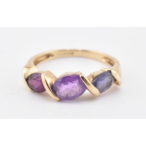 255 - A hallmarked 9ct gold amethyst, garnet and iolite three stone ring. The ring set with a single row c... 