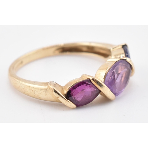 255 - A hallmarked 9ct gold amethyst, garnet and iolite three stone ring. The ring set with a single row c... 