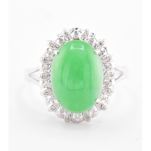 26 - A 18ct white gold jadeite cabochon and diamond ring, comes with box. The 18ct white gold ring set wi... 