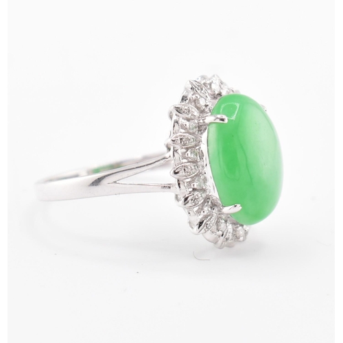 26 - A 18ct white gold jadeite cabochon and diamond ring, comes with box. The 18ct white gold ring set wi... 