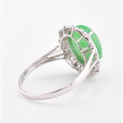 26 - A 18ct white gold jadeite cabochon and diamond ring, comes with box. The 18ct white gold ring set wi... 