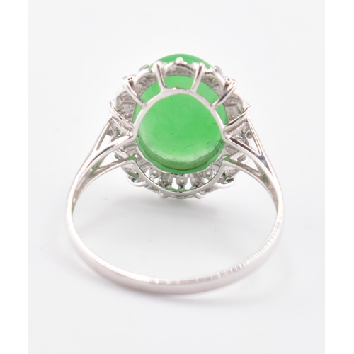 26 - A 18ct white gold jadeite cabochon and diamond ring, comes with box. The 18ct white gold ring set wi... 