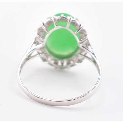 26 - A 18ct white gold jadeite cabochon and diamond ring, comes with box. The 18ct white gold ring set wi... 