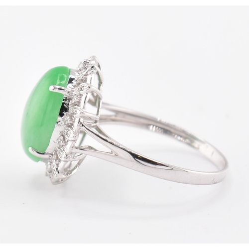 26 - A 18ct white gold jadeite cabochon and diamond ring, comes with box. The 18ct white gold ring set wi... 