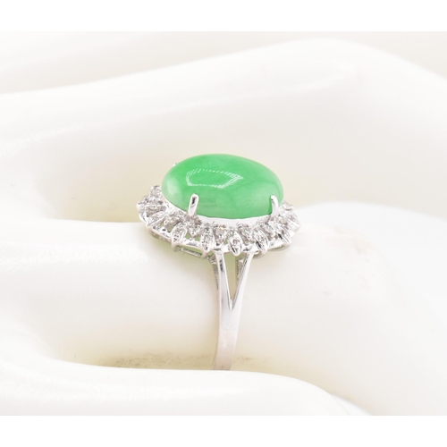 26 - A 18ct white gold jadeite cabochon and diamond ring, comes with box. The 18ct white gold ring set wi... 