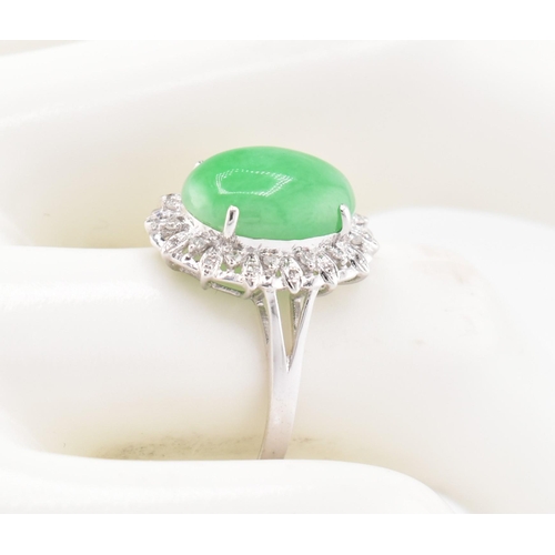 26 - A 18ct white gold jadeite cabochon and diamond ring, comes with box. The 18ct white gold ring set wi... 