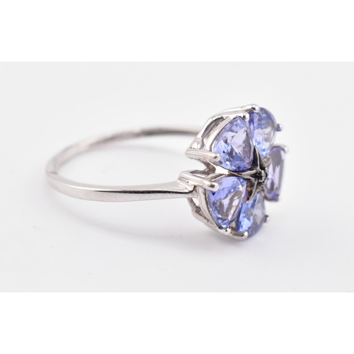 260 - A hallmarked 9ct white gold tanzanite and blue diamond flower ring. The 9ct white gold ring set with... 