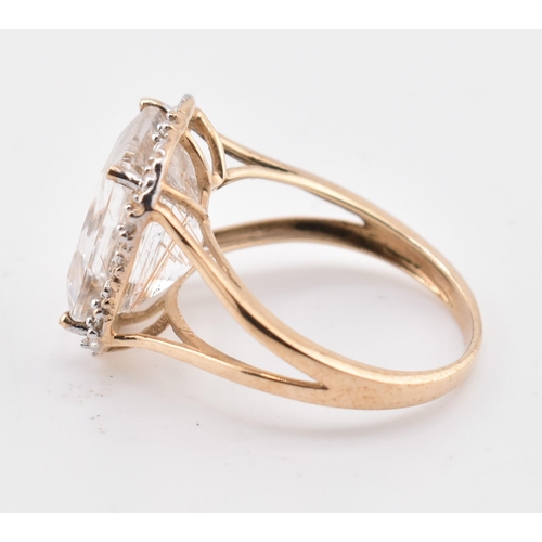 262 - A hallmarked 9ct gold rutile quartz and diamond ring. The 9ct yellow gold ring having a central octa... 