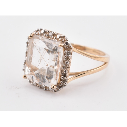 262 - A hallmarked 9ct gold rutile quartz and diamond ring. The 9ct yellow gold ring having a central octa... 