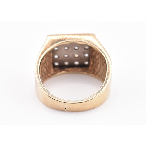 265 - A hallmarked 9ct gold and diamond signet ring. The 9ct yellow gold ring having 16 round brilliant cu... 