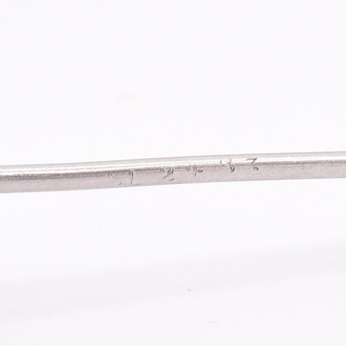 27 - A sapphire and diamond stick pin. The white gold stick pin having a head set with a central marquise... 