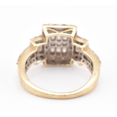 270 - A hallmarked 9ct gold, white and champagne diamond ring. The 9ct yellow gold ring set with 15 square... 