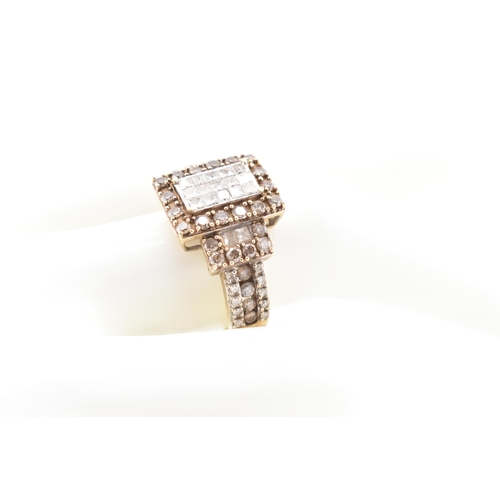 270 - A hallmarked 9ct gold, white and champagne diamond ring. The 9ct yellow gold ring set with 15 square... 