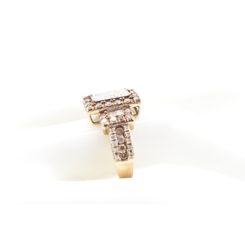 270 - A hallmarked 9ct gold, white and champagne diamond ring. The 9ct yellow gold ring set with 15 square... 