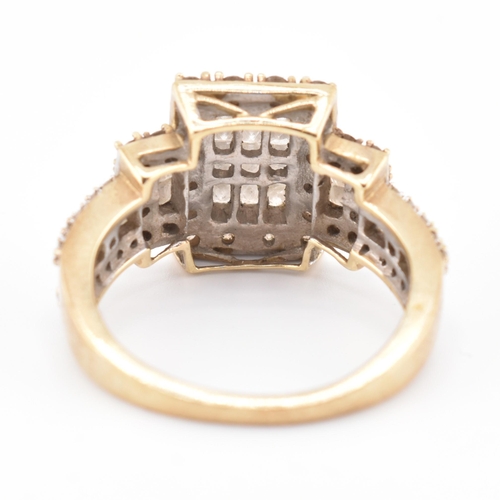 270 - A hallmarked 9ct gold, white and champagne diamond ring. The 9ct yellow gold ring set with 15 square... 