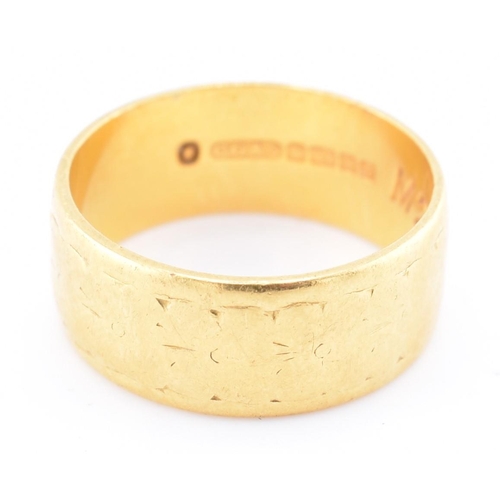 272 - A hallmarked 22ct gold engraved band ring. The 22ct yellow gold band ring having a rubbed engraved d... 