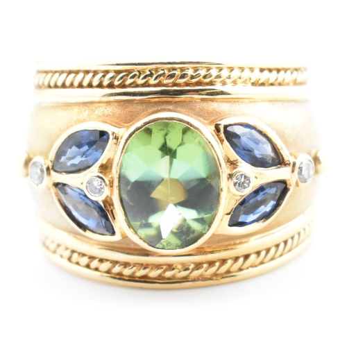 28a - An Etruscan style hallmarked 18ct gold, tourmaline, sapphire and diamond ring. The 18ct gold band ri... 