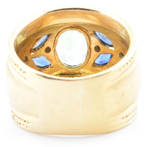 28a - An Etruscan style hallmarked 18ct gold, tourmaline, sapphire and diamond ring. The 18ct gold band ri... 