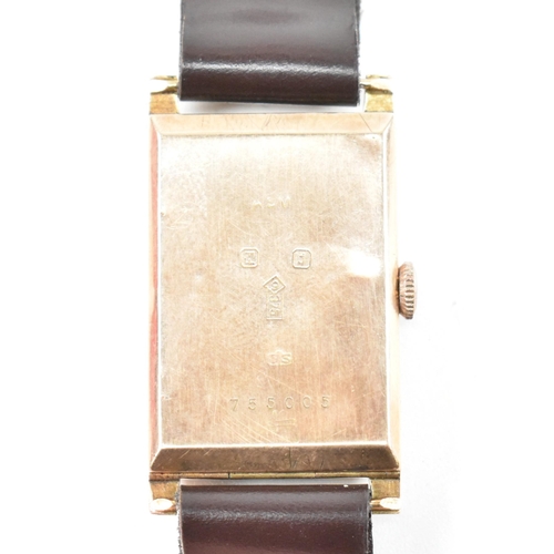 3 - A 1930s hallmarked 9ct gold jump hour wristwatch. The wristwatch having a hallmarked 9ct gold case w... 