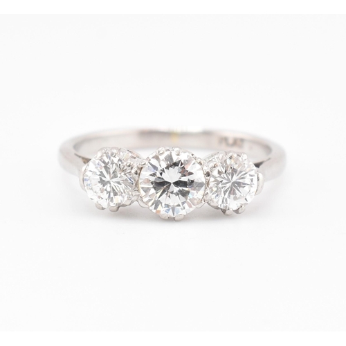 30 - A platinum and diamond three-stone ring. The trilogy ring having three claw set round brilliant cut ... 