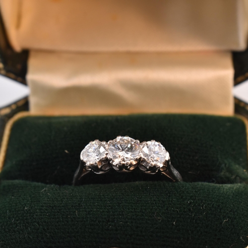 30 - A platinum and diamond three-stone ring. The trilogy ring having three claw set round brilliant cut ... 