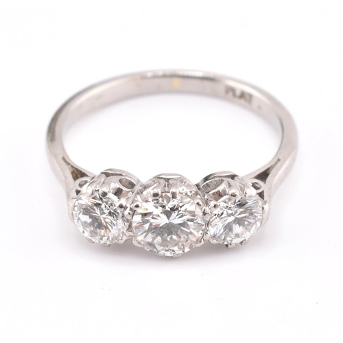 30 - A platinum and diamond three-stone ring. The trilogy ring having three claw set round brilliant cut ... 