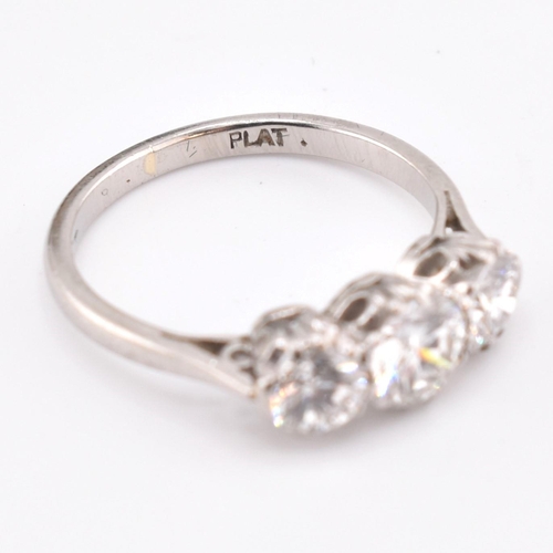 30 - A platinum and diamond three-stone ring. The trilogy ring having three claw set round brilliant cut ... 