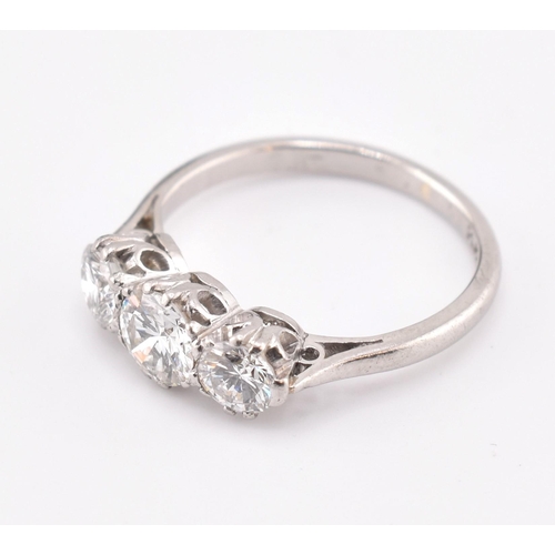 30 - A platinum and diamond three-stone ring. The trilogy ring having three claw set round brilliant cut ... 