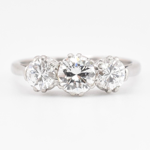 30 - A platinum and diamond three-stone ring. The trilogy ring having three claw set round brilliant cut ... 