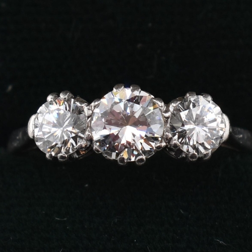 30 - A platinum and diamond three-stone ring. The trilogy ring having three claw set round brilliant cut ... 