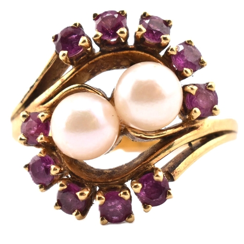 31 - A hallmarked 18ct gold ruby and pearl crossover ring. The 18ct yellow gold ring set with two round p... 