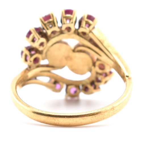 31 - A hallmarked 18ct gold ruby and pearl crossover ring. The 18ct yellow gold ring set with two round p... 