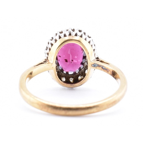 31A - An 18ct gold and platinum garnet and diamond cluster ring. The 18ct yellow gold ring set with a claw... 