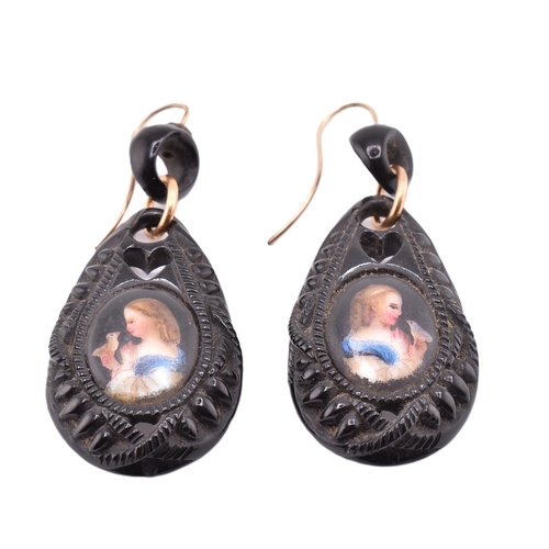 38A - A pair of Victorian carved jet portrait pendant earrings. The Victorian jet earrings having an oval ... 